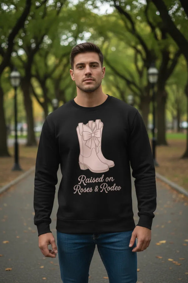 Man wearing a black sweatshirt with a graphic design in a park