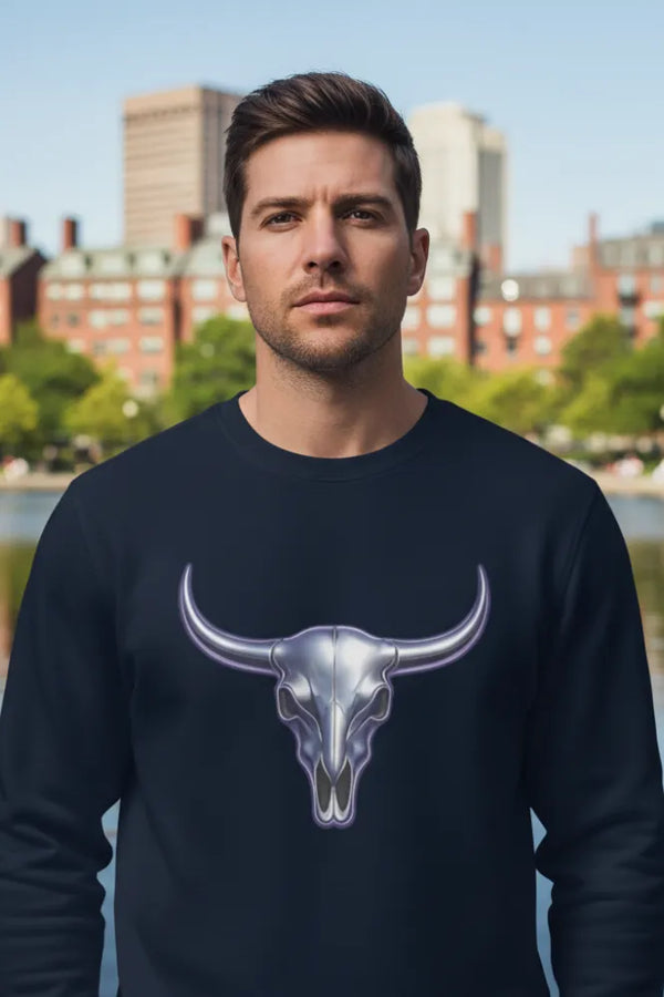 Man wearing a black sweatshirt with a bull skull design outdoors.