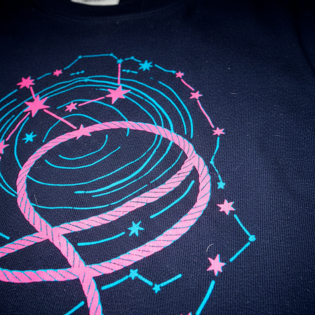 Rope the Cosmos Organic Cotton T-Shirt in French Navy featuring neon star graphic design and double-needle stitching details.