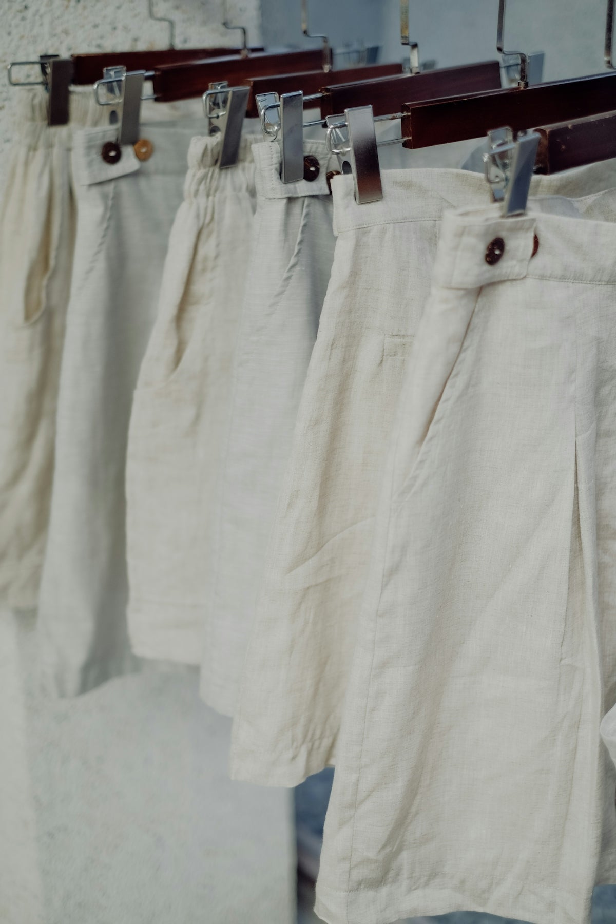 a row of white pants hanging on a clothes line