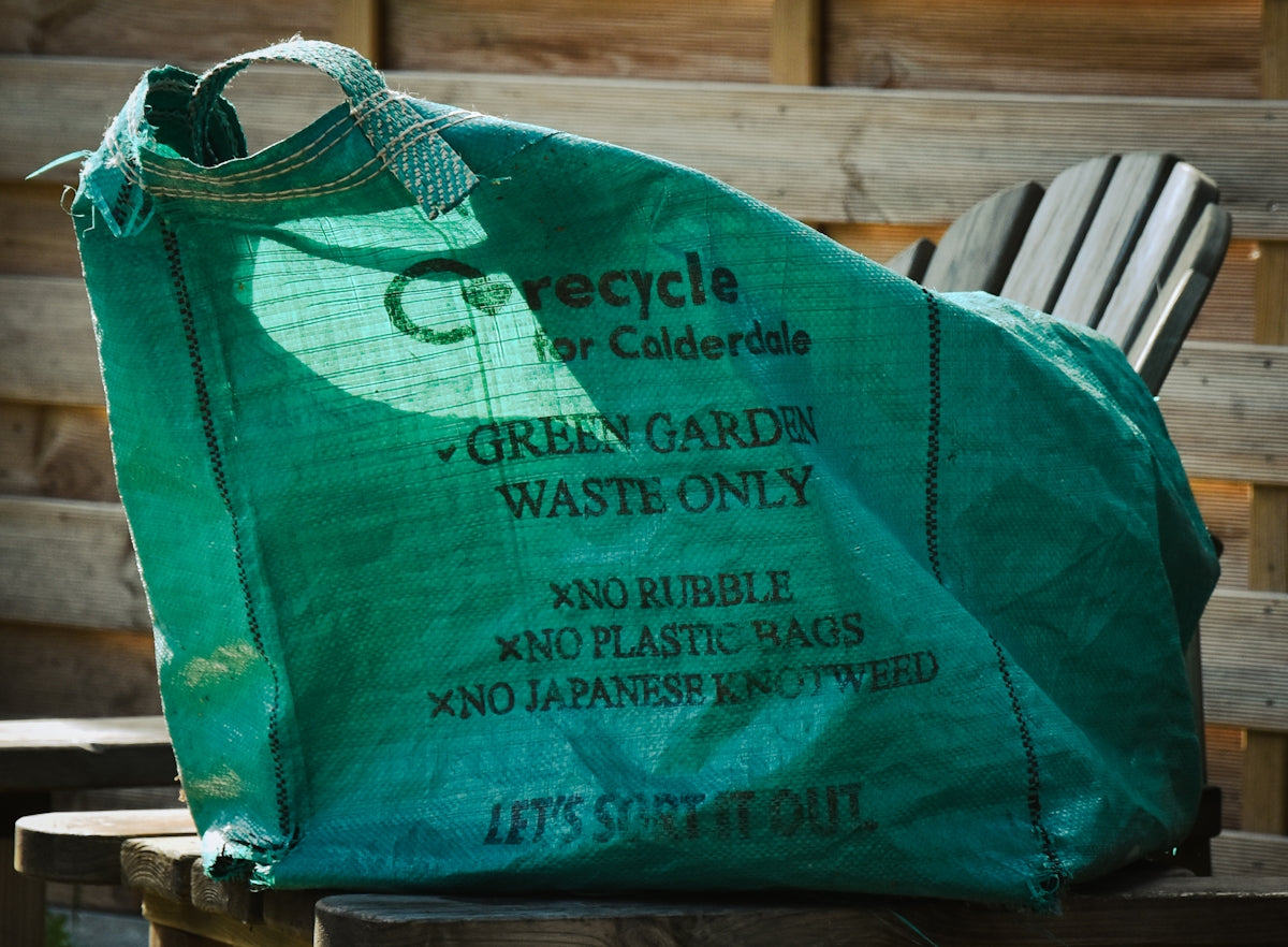 Green garden waste bag with instructions