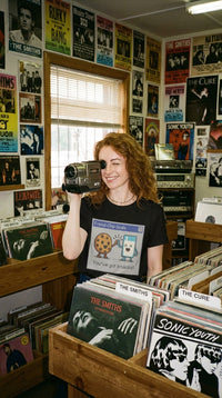 Unisex Organic Friend-Chip Tee - VHS Camcorder Operator in Vintage Record Store - 90s Grunge Revival