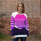 Person wearing a colorful striped sweater in front of a brick wall