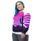 Person wearing a colorful striped sweater with a cactus design on a white background