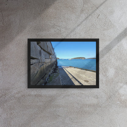 Framed canvas print of Bar Harbor, Maine’s seawall overlooking the ocean with distant islands, captured from a scenic coastal walkway against a clear blue sky.