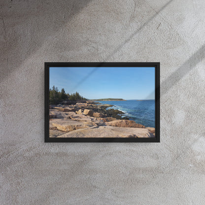 Framed Bar Harbor, Maine canvas print featuring a rocky shoreline and serene ocean view, displayed against a scenic downtown background with autumn foliage.