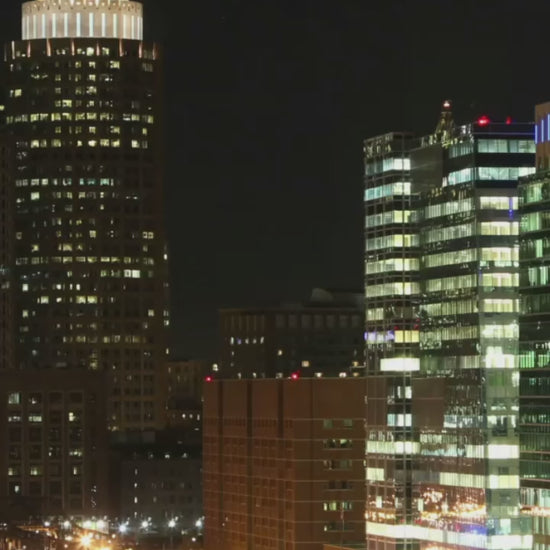 Nighttime cityscape of Boston featuring illuminated landmarks and a serene skyline, perfect for adding a touch of urban elegance to your home decor.