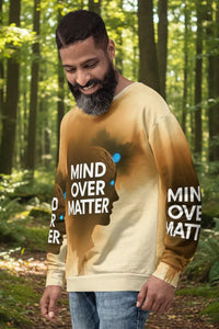 Man wearing a gradient sweatshirt with 'Mind Over Matter' text in a forest setting