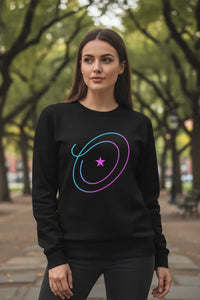 Woman wearing a black sweatshirt with a colorful design in an outdoor setting