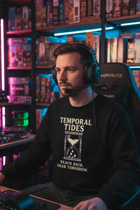 Person wearing headphones and a black sweatshirt with text in a gaming setup.