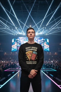 Person wearing a black sweatshirt with a pizza graphic and text, standing on a stage with bright lights and an audience.