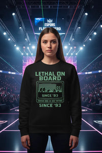 Person wearing a black sweatshirt with text in front of a large screen displaying 'Espoirs'.