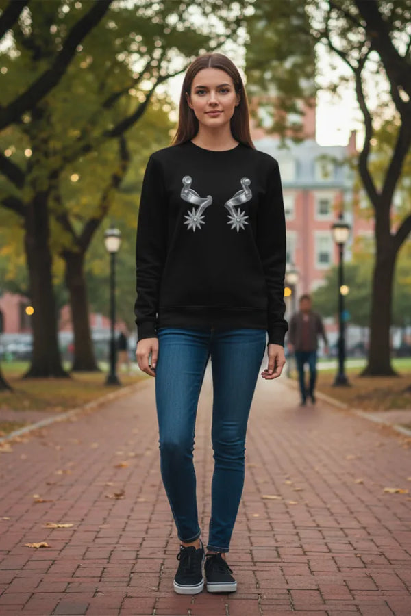 Woman wearing a black sweatshirt with a graphic design in an outdoor setting