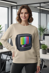 Woman wearing a beige sweatshirt with a colorful TV graphic in an office setting