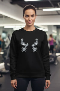 Woman wearing a black sweatshirt with silver star designs in a gym setting