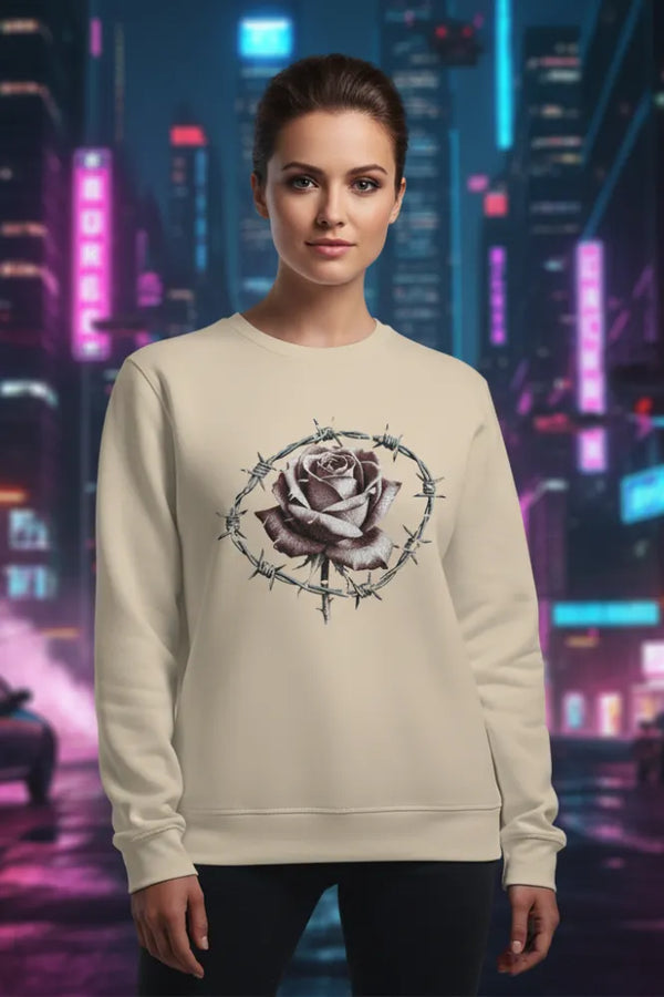 Person wearing a beige sweatshirt with a rose and barbed wire design against a futuristic cityscape background.