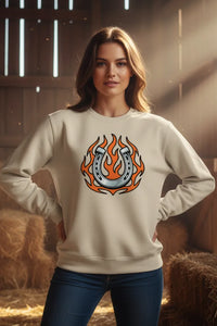 Woman wearing a white sweatshirt with a graphic design in a barn setting