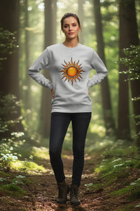 Person wearing a sweater with a sun design in a forest