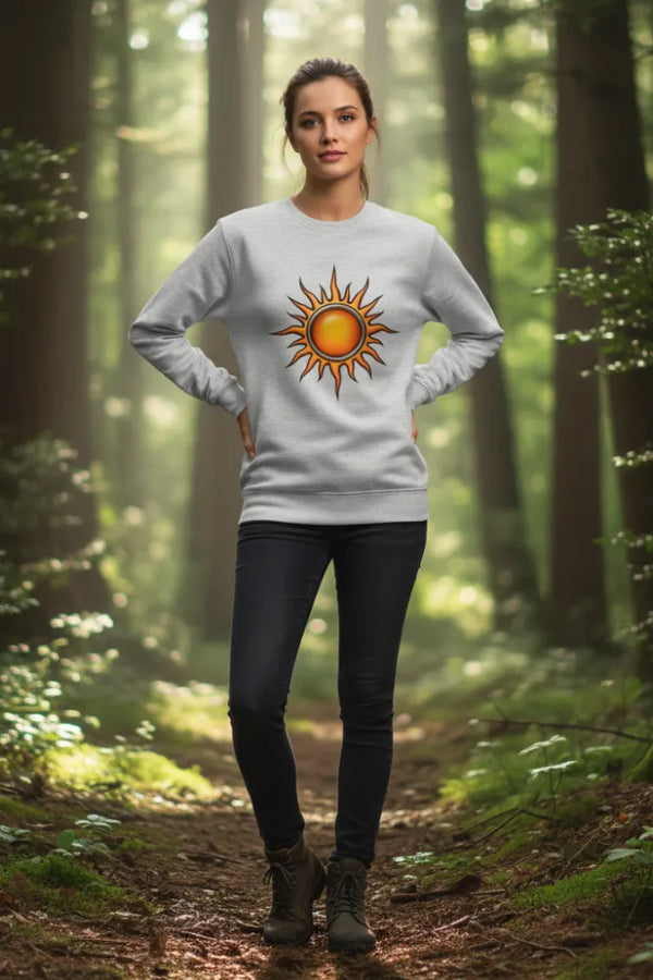 Person wearing a sweater with a sun design in a forest
