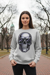 Woman wearing a gray sweatshirt with a skull design outdoors.