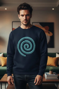 Man wearing a navy blue sweater with a green spiral design in a living room.