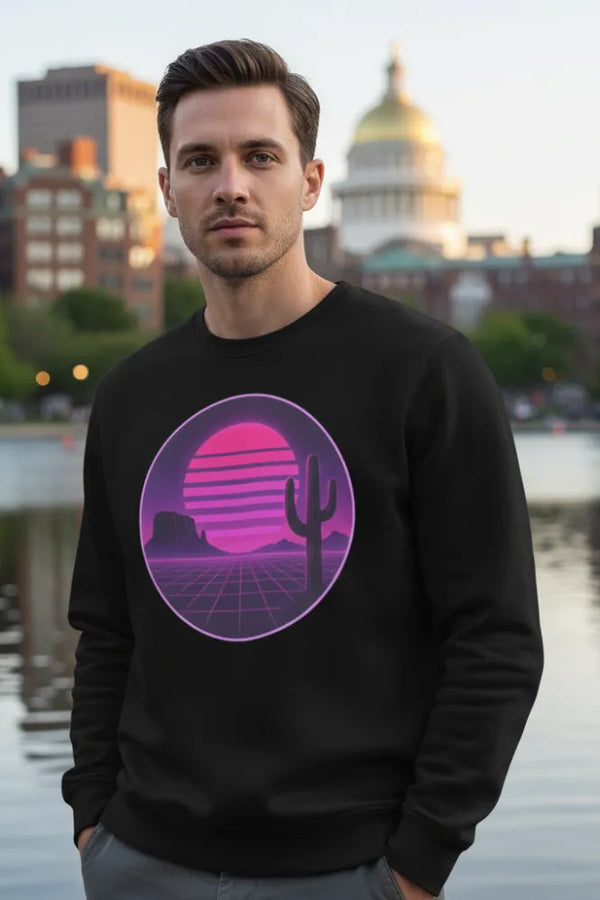 Man wearing a black sweatshirt with a pink and purple graphic design standing by a waterfront.