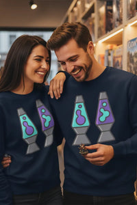 Two people wearing matching navy blue sweatshirts with lava lamp designs, standing close together in a store.