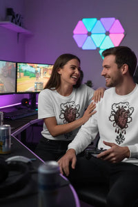 Two people sitting together in a gaming setup with colorful LED lights in the background.