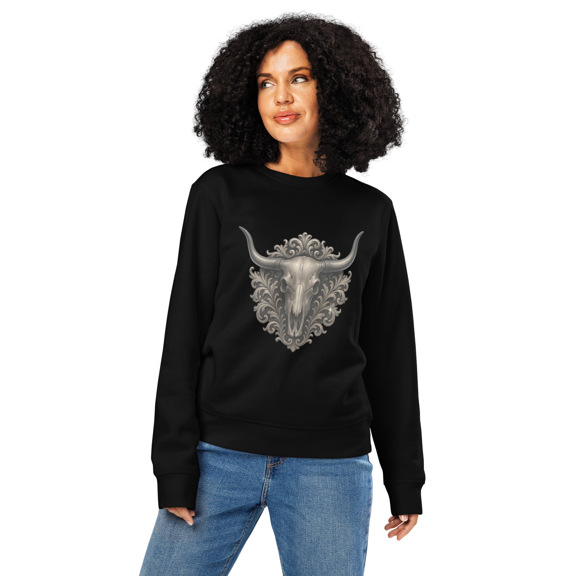 Woman wearing a black sweatshirt with a decorative bull skull design on a white background