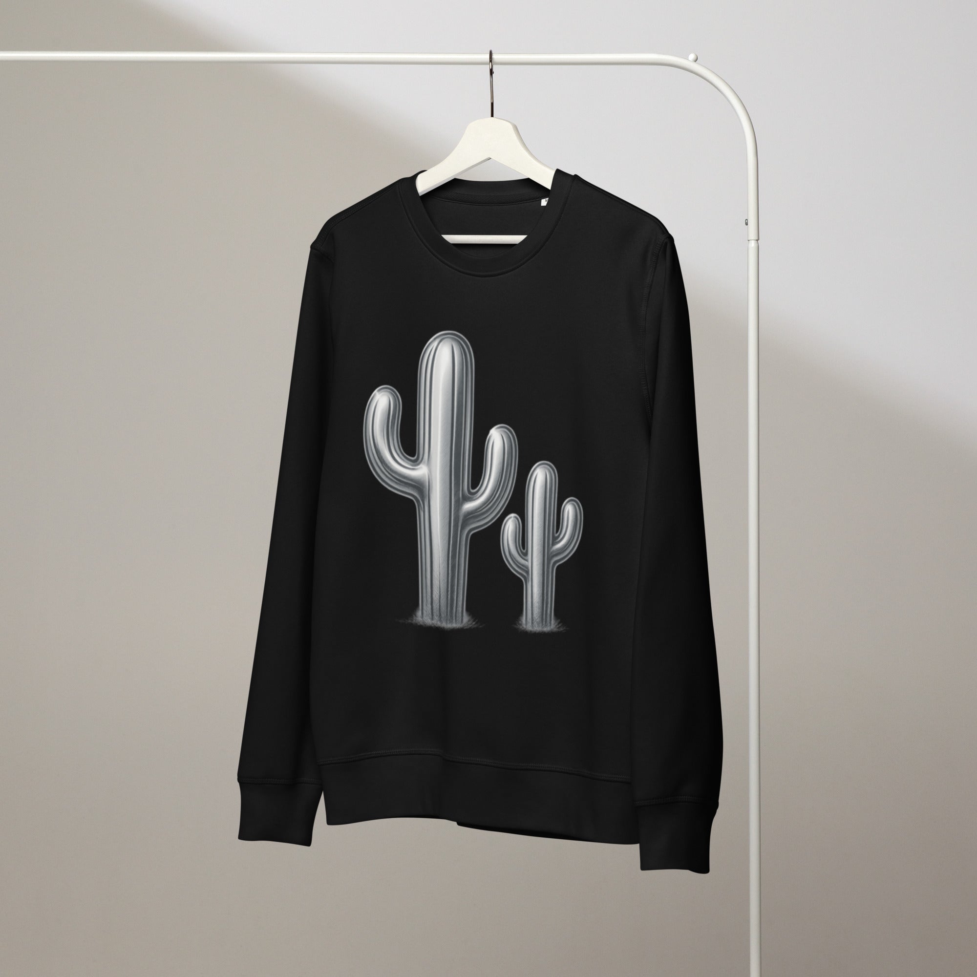 Black sweatshirt with cactus design on a hanger against a neutral background