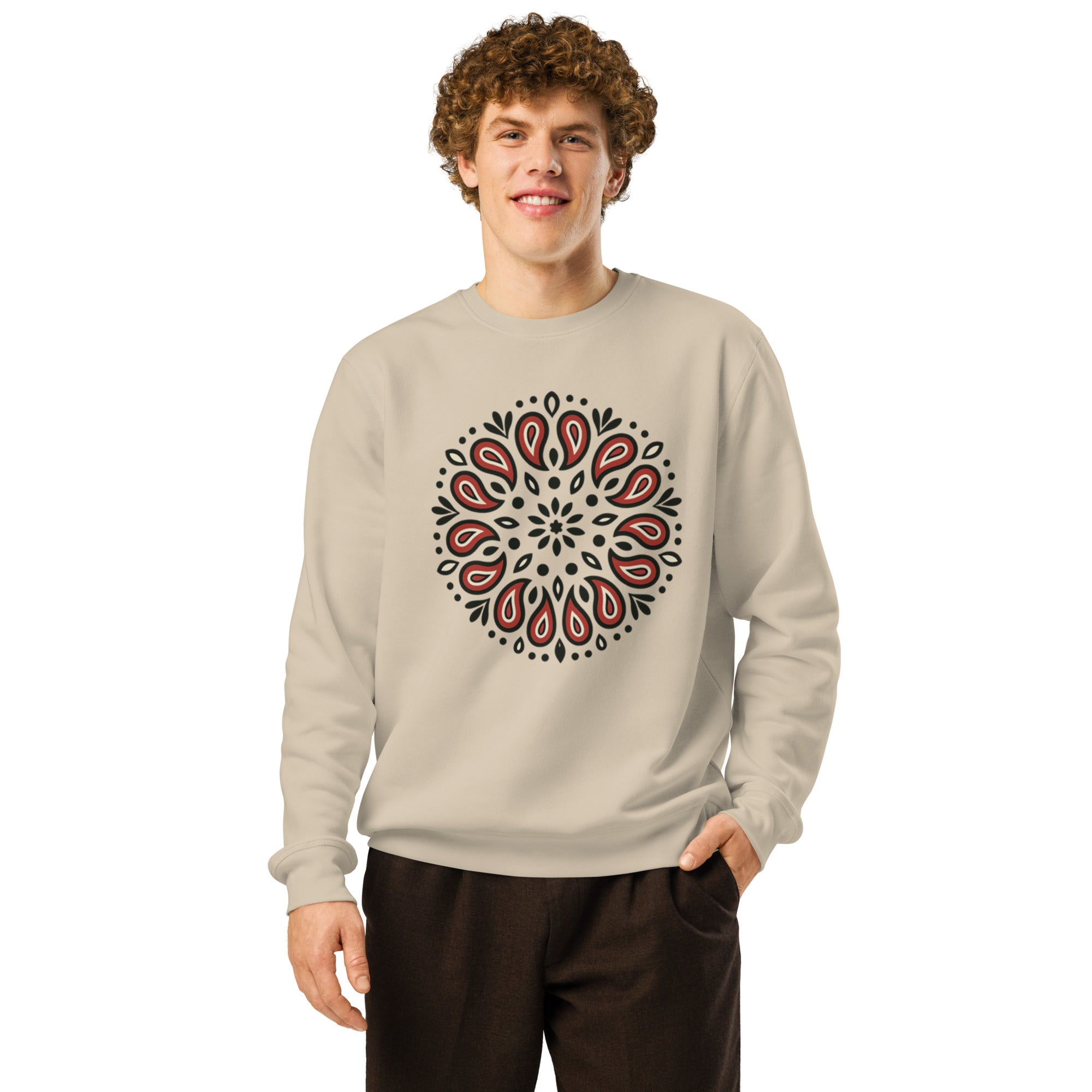 Man wearing a beige sweatshirt with a red and black pattern on a white background