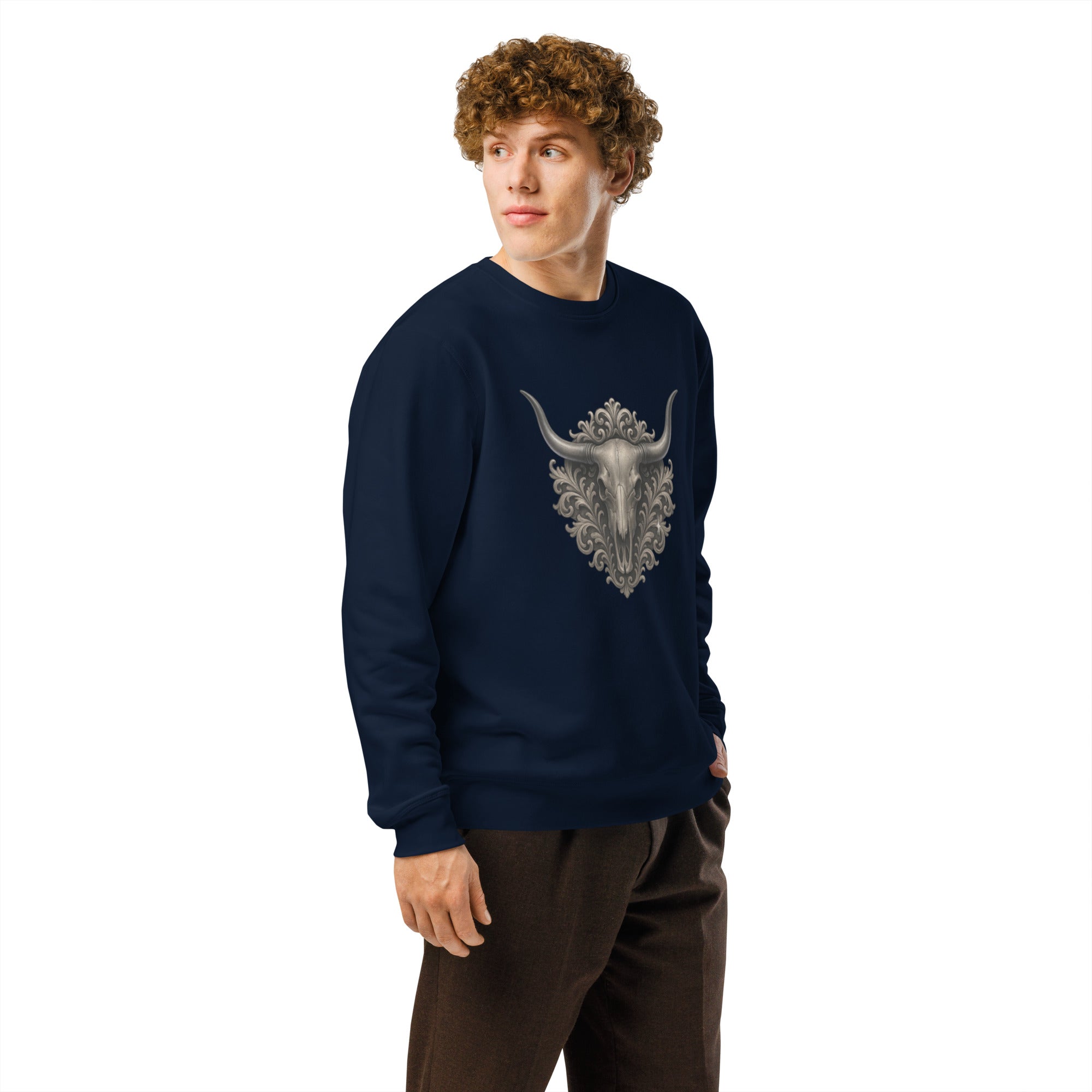 Person wearing a navy blue sweatshirt with a bull skull design on a white background