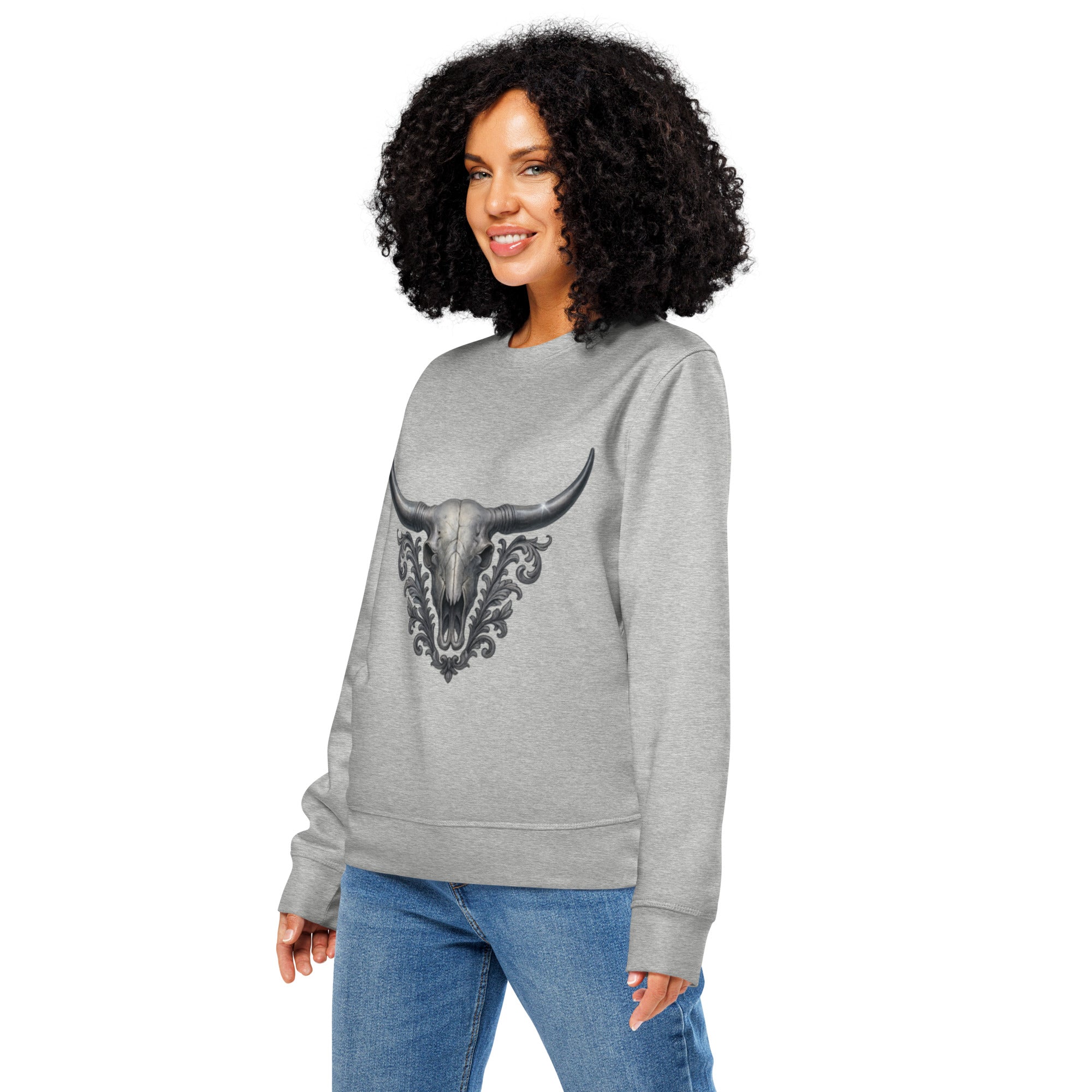 Woman wearing a gray sweatshirt with a bull skull design on a white background